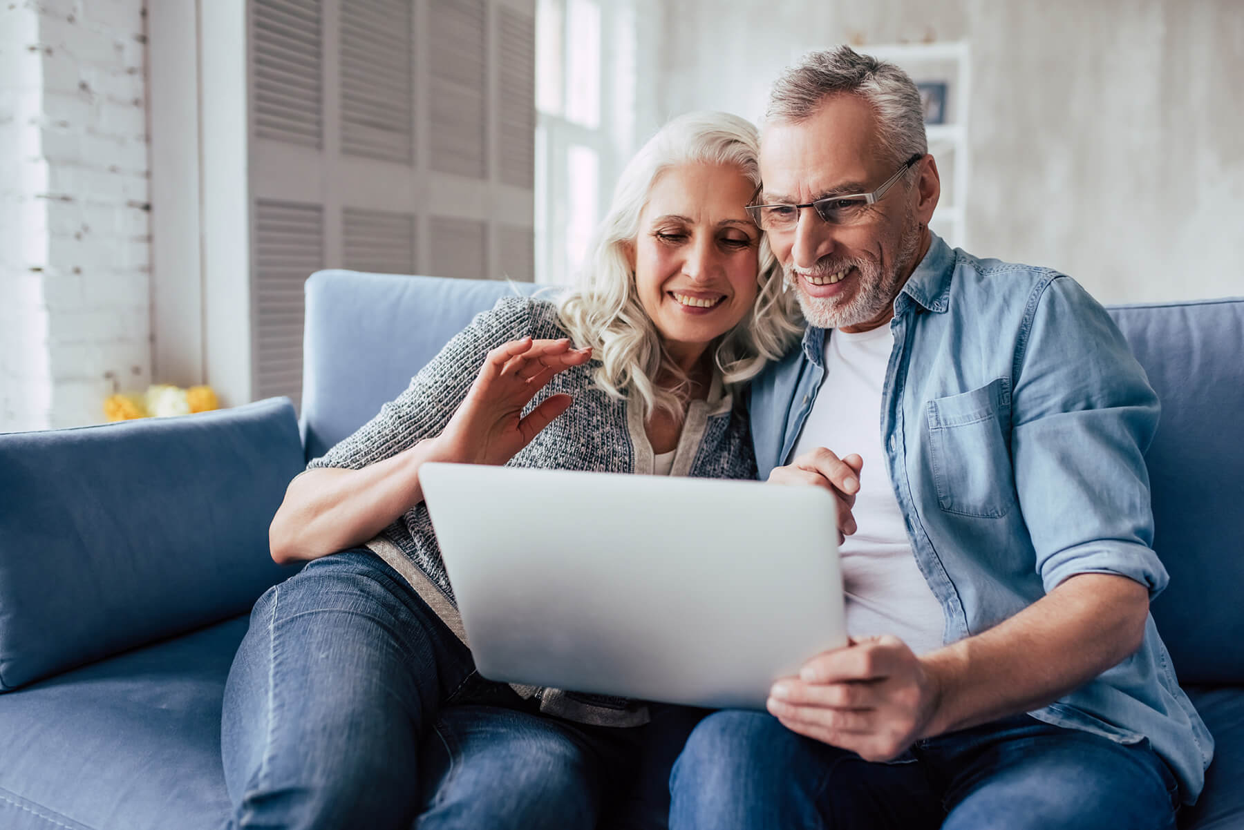 a couple facing laptop and staring at it