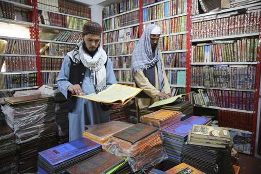Afghans read books in a specialized religious bookstore in Kabul, Afghanistan, Tuesday, April 23, 2…
