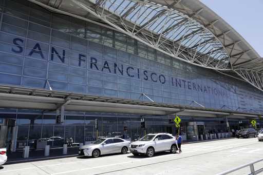 Vehicles wait outside the international terminal at San Francisco International Airport in San Fran…