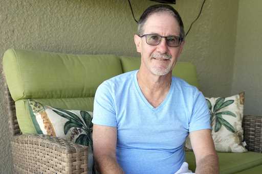 Scott Berkheiser, 57, who has Alzheimer's disease, sits for a portrait at his home Friday, April 5,…
