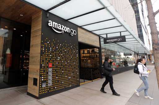 People walk out of an Amazon Go store in Seattle, March 4, 2020. (AP Photo/Ted S. Warren, File)
