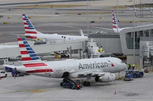 American Airlines planes sit on the tarmac at Terminal B at LaGuardia Airport, January 11, 2023, in…