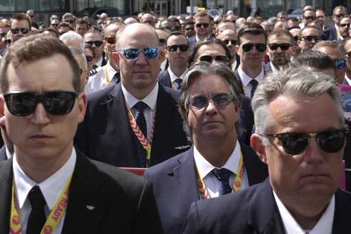 WestJet Airlines pilots assemble for a group photo after standing on a picket line at Toronto Pears…