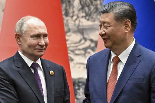 Chinese President Xi Jinping, right, and Russian President Vladimir Putin look toward each other as…