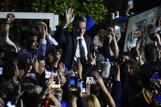 Greece's Prime Minister and leader of New Democracy Kyriakos Mitsotakis, center, addresses supporte…