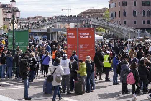 Stewards check tourists QR code access outside the main train station in Venice, Italy, Thursday, A…