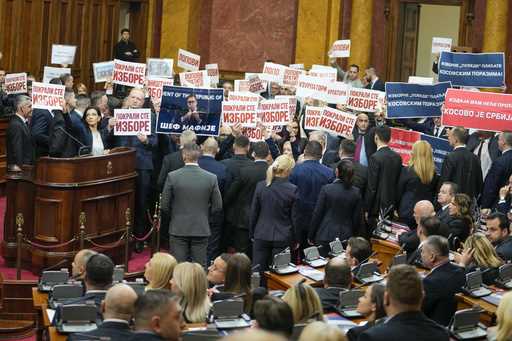 Opposition lawmakers hold banners reading: 