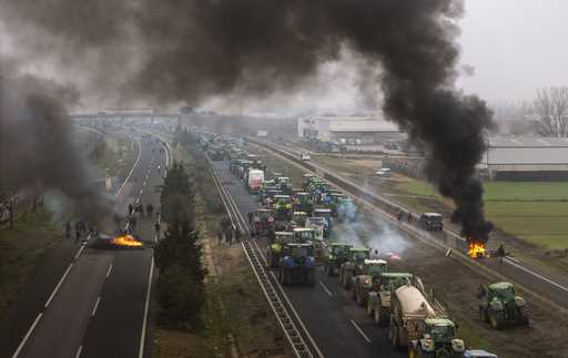 Farmers make barricades after blocking a highway during a protest near Mollerussa, northeast Spain,…