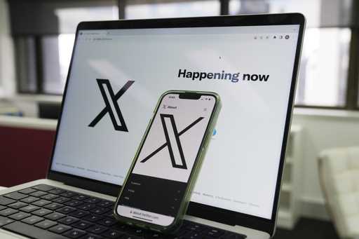 The opening page of X is displayed on a computer and phone in Sydney on October 16, 2023