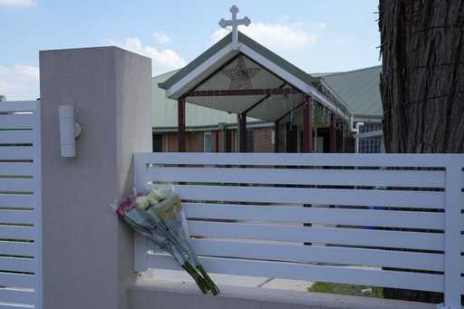 Flowers sit on a fence outside the Christ the Good Shepherd church in suburban Wakely in western Sy…
