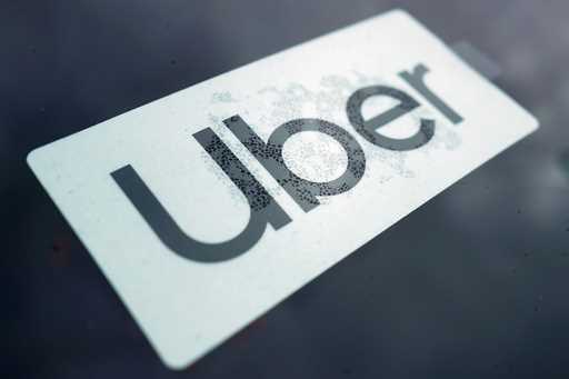 An Uber sign is displayed inside a car in Palatine, Ill