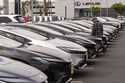 A person looks at a new vehicle at a Toyota dealership in El Monte, Calif