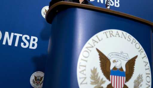 The National Transportation Safety Board logo and signage are seen at a news conference at NTSB hea…