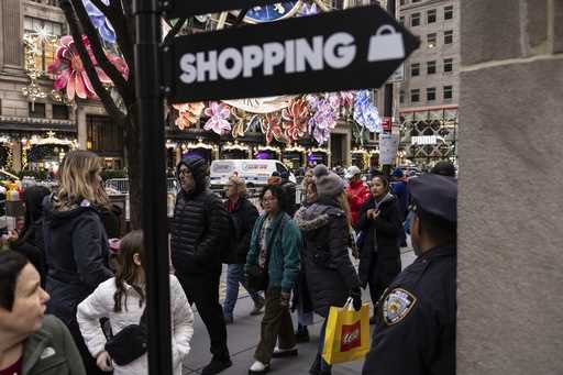 Shoppers and sightseers walk on Fifth Avenue on December 11, 2023, in New York