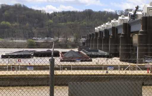 A group of barges sit pinned against the Emsworth lock and dam in Pittsburgh, on Saturday, April 13…