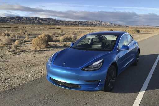 This photo provided by Edmunds shows a 2017 Tesla Model 3 fitted with an aftermarket vinyl wrap