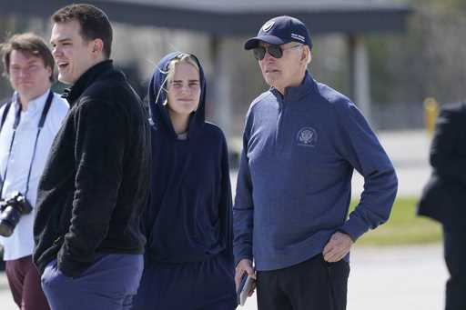 President Joe Biden and his granddaughter Maisy Biden stretch their legs during a refueling stop at…