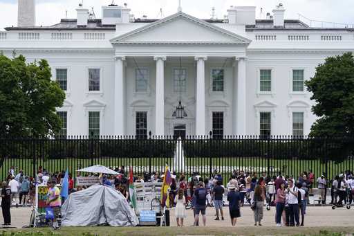 People gather on a section of Pennsylvania Avenue in front of the White House, July 4, 2021, in Was…