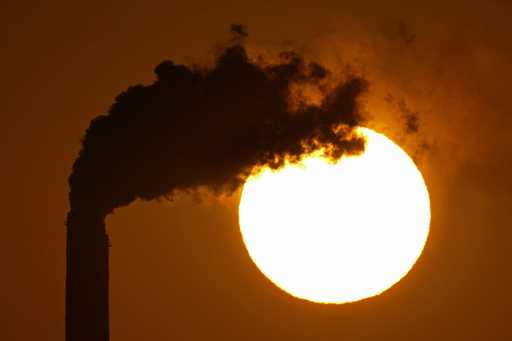 Emissions rise from the smokestacks at the Jeffrey Energy Center coal power plant as the suns sets …