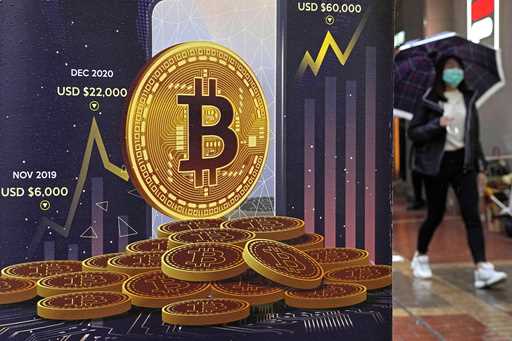 An advertisement for Bitcoin cryptocurrency is displayed on a street in Hong Kong, on February 17, …