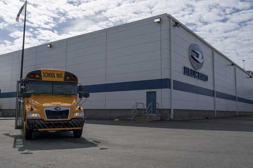 FILE -- An all-electric school bus sits on display in front of the Blue Bird Corp