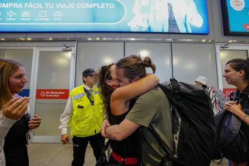 FILE -Passenger Diego Valenzuela is embraced by his mother Solange Somerville after he arrived from…