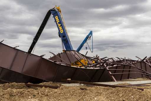 Twisted girders and debris cover the ground from a deadly structure collapse at a construction site…