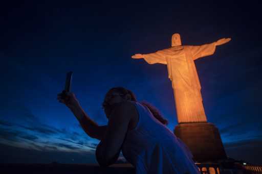A tourist takes a selfie with the Christ the Redeemer statue in Rio de Janeiro, Brazil, November 25…