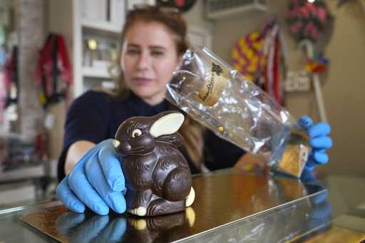 Niaz Mardan wraps a luxury handmade Belgian chocolate rabbit at Sandrine a chocolate shop in south …