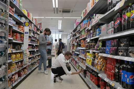 Shoppers buy food in a supermarket in London, Wednesday, August 17, 2022