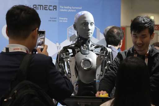 A robot designed by Engineers Arts and called AMECA, interacts with visitors during the Internation…