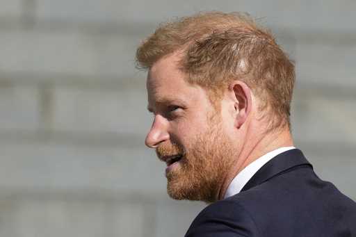 Prince Harry looks round as he arrives at St Paul's Cathedral for a 'Service of Thanksgiving' celeb…
