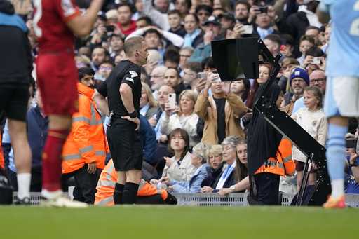 Referee checks VAR for penalty during the English Premier League soccer match between Manchester Ci…
