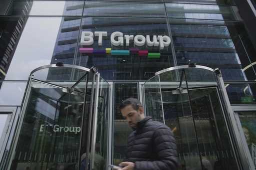 A man walks in front of the BT headquarters, in London, Thursday, May 18, 2023