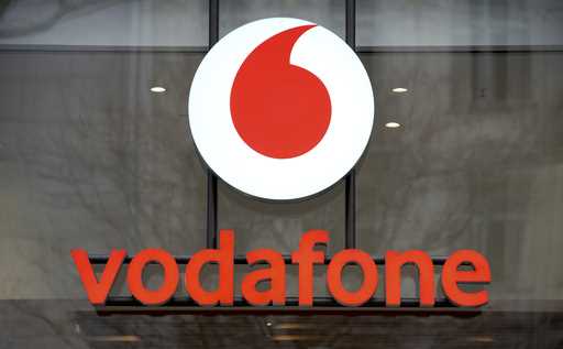 The logo of the mobile service provider 'vodafone' is pictured on the entrance of a company's store…