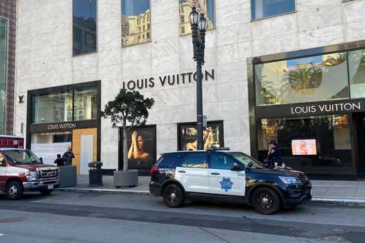 Police officers and emergency crews park outside the Louis Vuitton store in San Francisco's Union S…