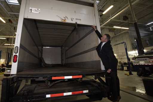 Police officers open the back of a recovered truck during a press conference regarding Project 24K …