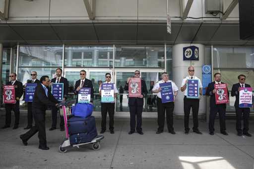 WestJet Airlines pilots stand on a picket line at Toronto's Pearson Airport on Monday May 8, 2023