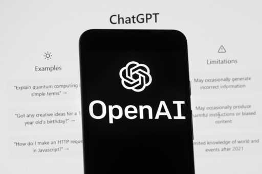 The OpenAI logo is seen on a mobile phone in front of a computer screen displaying the ChatGPT home…