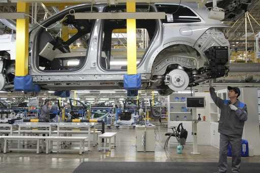 A worker assembles an SUV at a car plant of Li Auto, a major Chinese EV maker, in Changzhou in east…