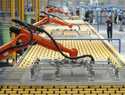 Kuka robots work on the production line of flat glass for solar panels at a subsidiary plant of Hos…