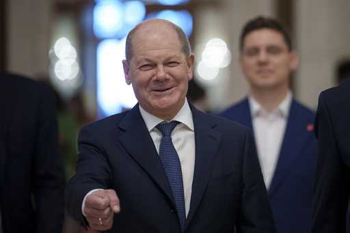 German Chancellor Olaf Scholz gestures as he arrives at the Party of European Socialists…