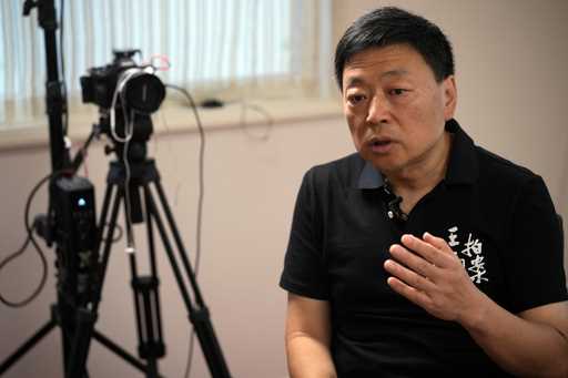 FILE- Wang Zhi'an speaks during an interview with the Associated Press in Tokyo on October 5, 2022