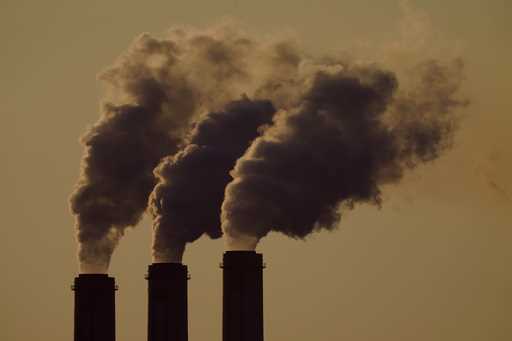 Emissions rise from the smokestacks at the Jeffrey Energy Center coal power plant as the suns sets,…