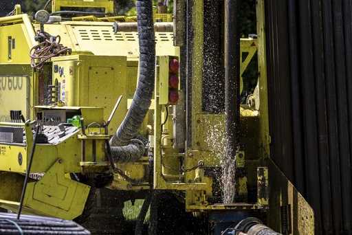 Groundwater squirts up during drilling for a geothermal heating and cooling system at a home in Whi…