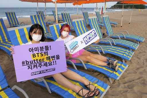 In this image provided by Kpop4Planet, demonstrators pose at Maengbang Beach in Samcheok, South Kor…