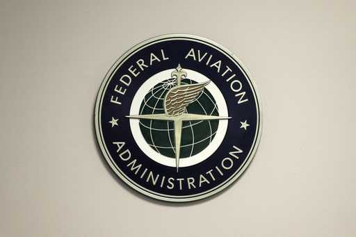A Federal Aviation Administration sign hangs in the tower at John F