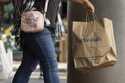 File - A shopper carries a Marshalls bag, Friday, October 14, 2022, in Boston