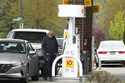 A customer fills up his vehicle's gas tank at a gas station in Buffalo Grove, Ill