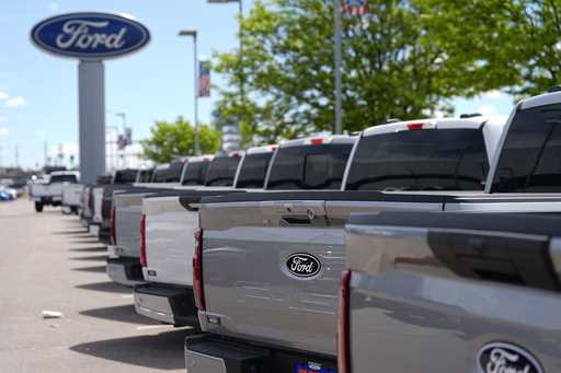 A line of unsold 2024 F150 pickup trucks sit at a Ford dealership Sunday, May 19, 2024, in Denver